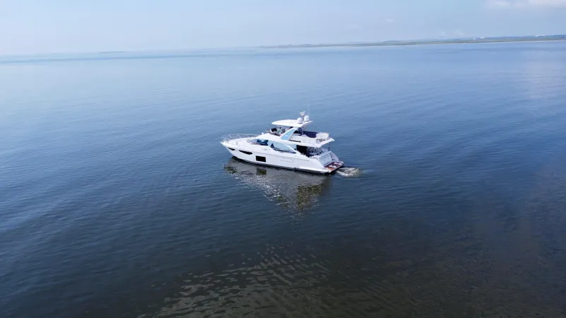 Slide: The Image of 2022 Azimut Fly 60 yacht cruising on calm blue waters. - 23