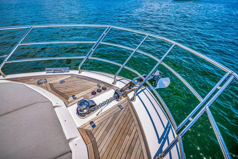 Slide: The Image of Bow of 2022 Azimut Fly 60 yacht with teak decking and stainless steel railings. - 28