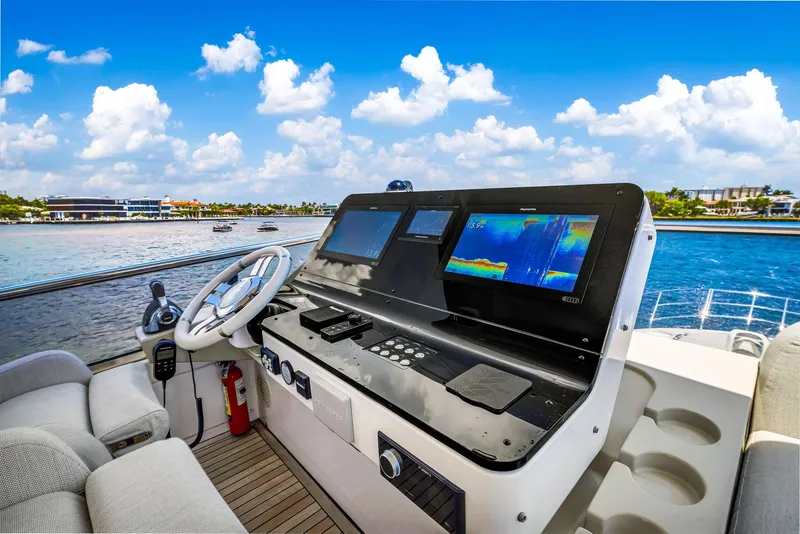 Slide: The Image of Helm of 2022 Azimut Fly 60 yacht with navigation screens and ocean view. - 36