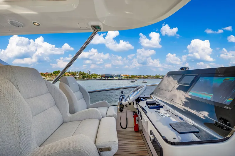 Slide: The Image of Luxurious 2022 Azimut Fly 60 yacht cockpit with plush seating and modern controls, overlooking serene waters. - 37