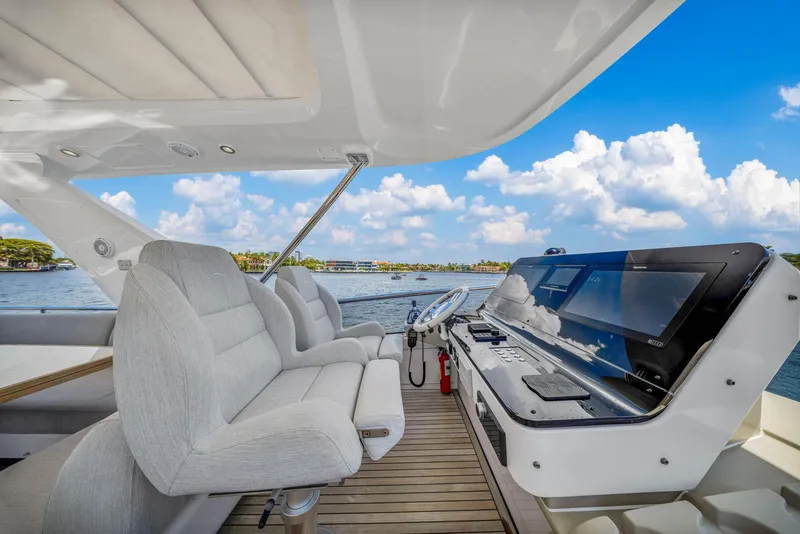 Slide: The Image of 2022 Azimut Fly 60 yacht cockpit with luxurious seating and modern navigation system. - 38