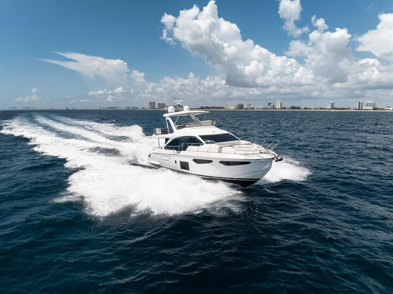 Slide: The Image of 2022 Azimut Fly 60 yacht cruising on open sea under a clear blue sky. - 4