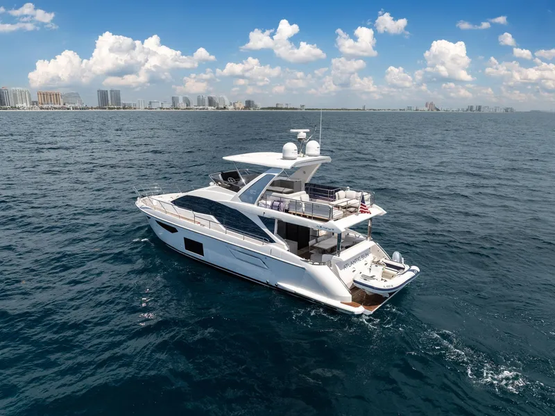 Slide: The Image of 2022 Azimut Fly 60 yacht cruising on open sea under blue sky. - 5