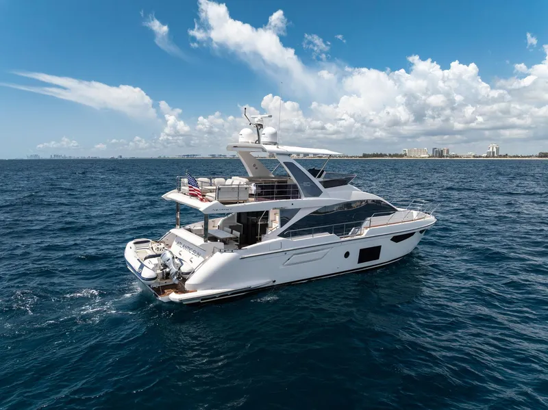 Slide: The Image of 2022 Azimut Fly 60 yacht cruising on open sea under blue sky. - 7