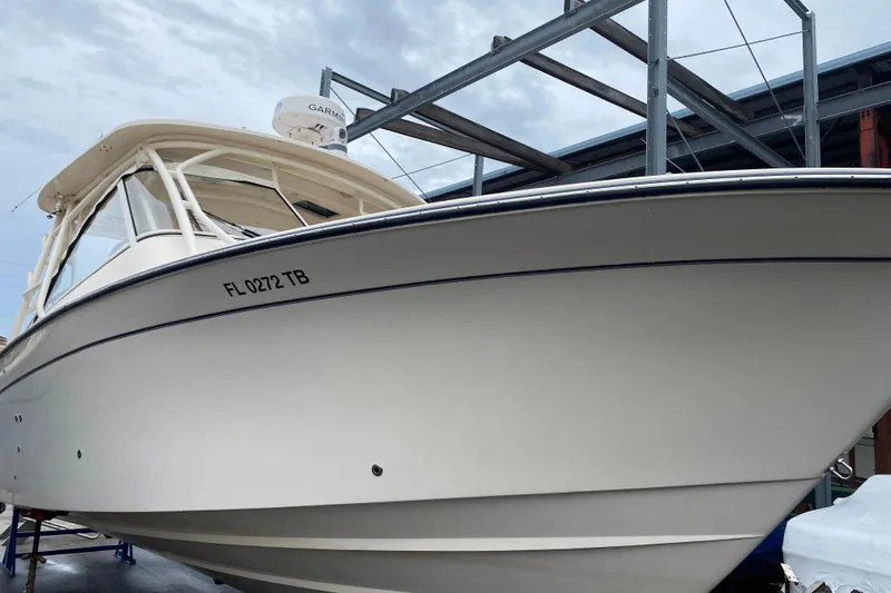 Slide: The Image of 2021 Grady-White Freedom 335 boat docked, featuring sleek design and Garmin equipment. - 1