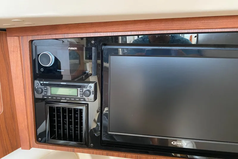 Slide: The Image of 2021 Grady-White Freedom 335 boat interior with Fusion audio system and Jensen display. - 11