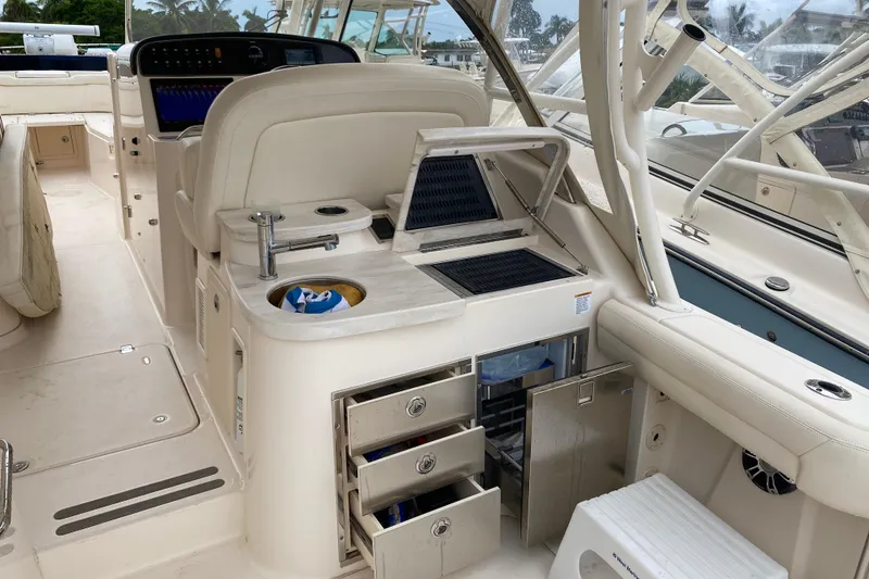 Slide: The Image of 2021 Grady-White Freedom 335 boat interior with seating, storage, and control panel. - 13