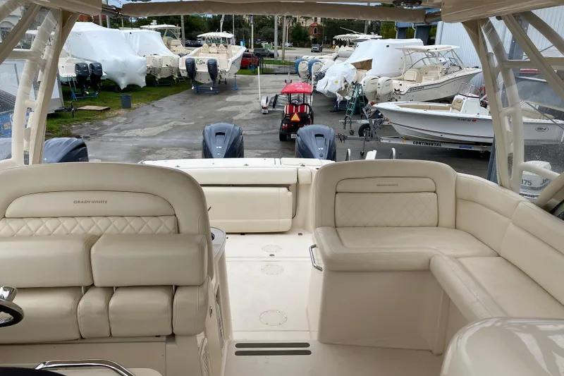 Slide: The Image of 2021 Grady-White Freedom 335 boat interior with luxurious seating and multiple outboard engines. - 15