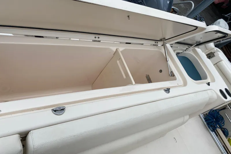 Slide: The Image of 2021 Grady-White Freedom 335 boat storage compartment open, showcasing spacious interior. - 17