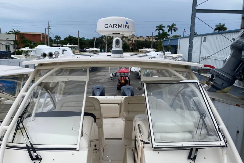 Slide: The Image of 2021 Grady-White Freedom 335 boat with Garmin equipment, docked in a marina. - 2