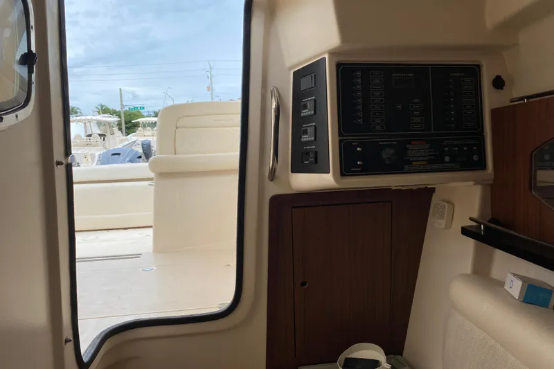 Slide: The Image of Interior view of 2021 Grady-White Freedom 335 boat, featuring control panel and seating area. - 9