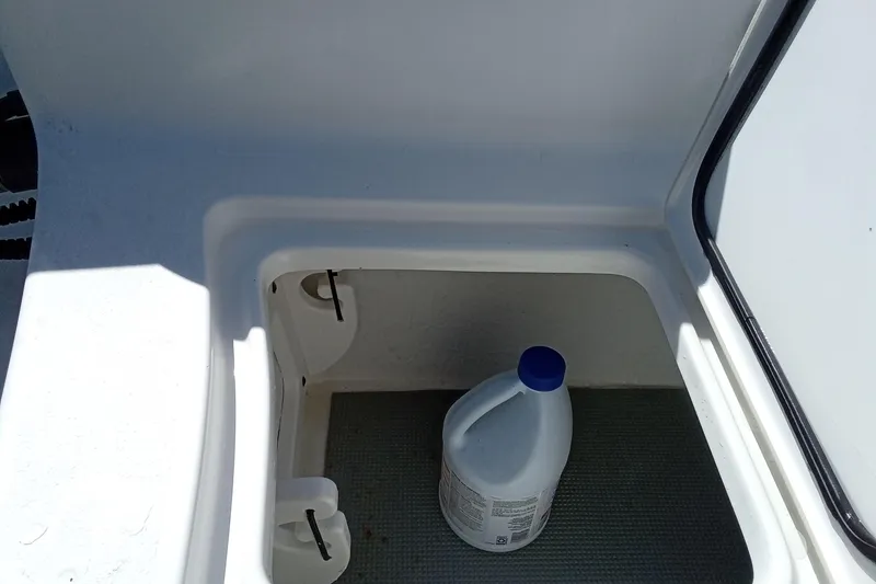 Slide: The Image of Storage compartment in 2019 Sea Hunt Ultra 255 SE boat with cleaning product. - 10