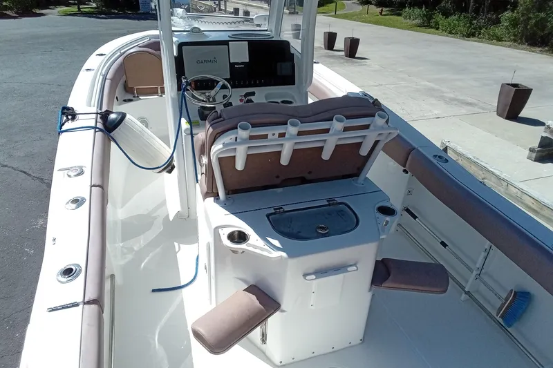 Slide: The Image of 2019 Sea Hunt Ultra 255 SE boat interior with helm and seating. - 12