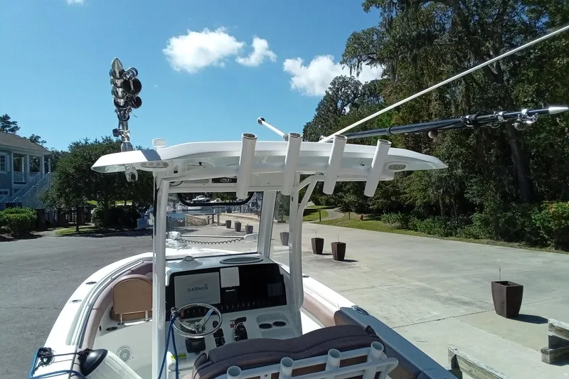Slide: The Image of 2019 Sea Hunt Ultra 255 SE boat with fishing rod holders and Garmin equipment. - 13
