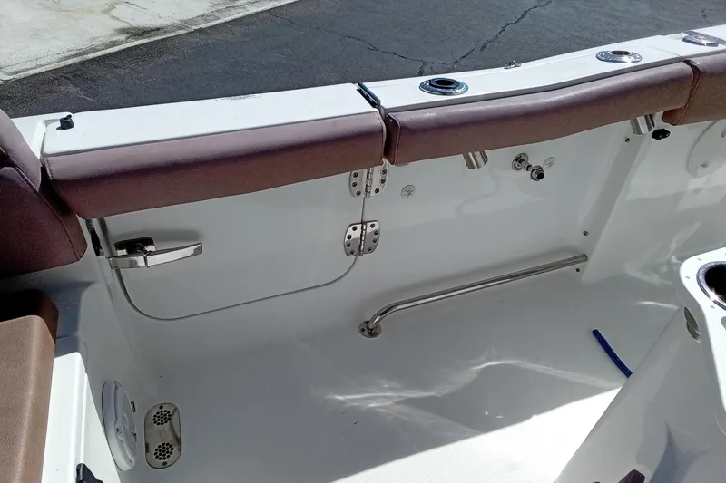 Slide: The Image of 2019 Sea Hunt Ultra 255 SE boat interior with seating and stainless steel fixtures. - 15