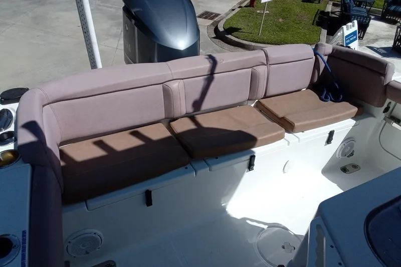 Slide: The Image of 2019 Sea Hunt Ultra 255 SE boat interior with cushioned seating and storage compartments. - 16