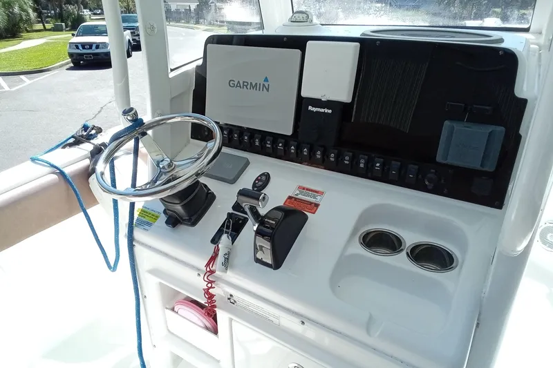 Slide: The Image of Control panel of a 2019 Sea Hunt Ultra 255 SE boat with Garmin and Raymarine equipment. - 17