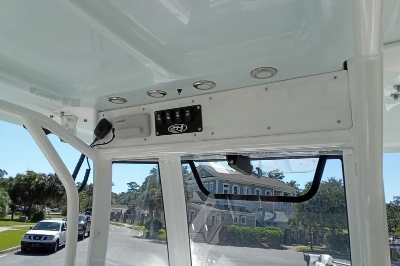 Slide: The Image of Interior view of a 2019 Sea Hunt Ultra 255 SE boat, showcasing control panel and electronics. - 19
