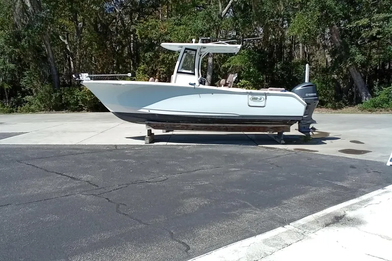 Slide: The Image of 2019 Sea Hunt Ultra 255 SE boat on trailer, parked outdoors. - 2