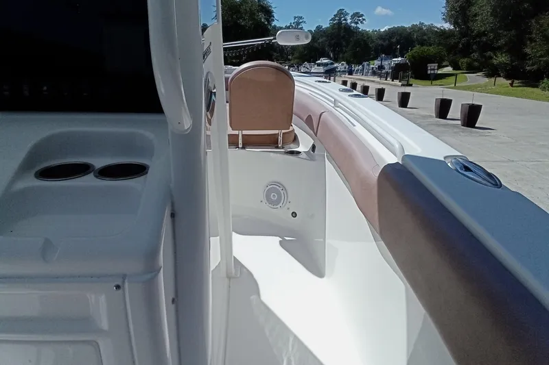 Slide: The Image of 2019 Sea Hunt Ultra 255 SE boat interior with seating and cup holders. - 21