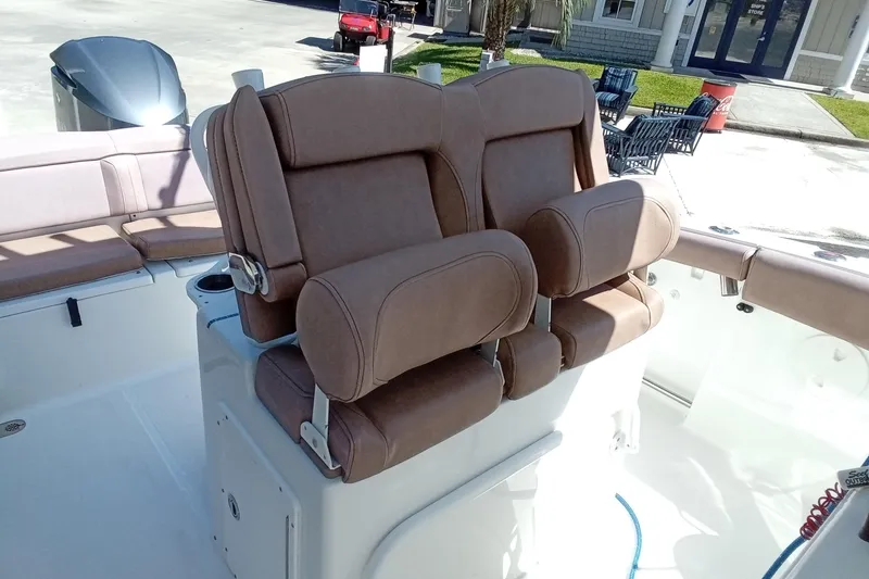 Slide: The Image of 2019 Sea Hunt Ultra 255 SE boat with brown cushioned seating. - 22