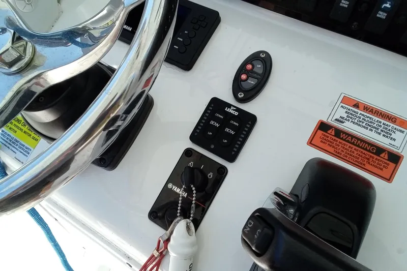 Slide: The Image of 2019 Sea Hunt Ultra 255 SE boat dashboard with steering wheel and control panel. - 26