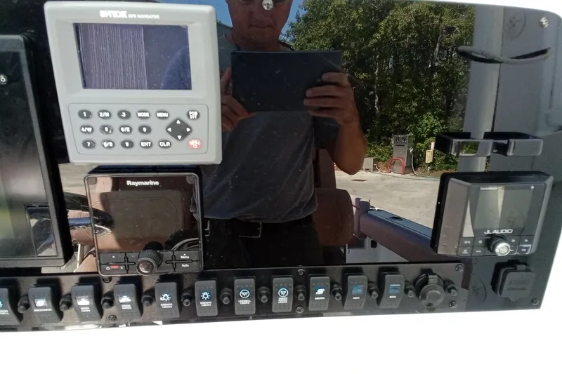 Slide: The Image of Control panel of a 2019 Sea Hunt Ultra 255 SE boat with navigation equipment. - 27