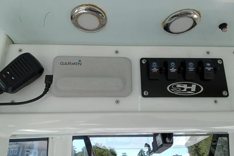 Slide: The Image of Control panel of 2019 Sea Hunt Ultra 255 SE with Garmin device and light switches. - 29