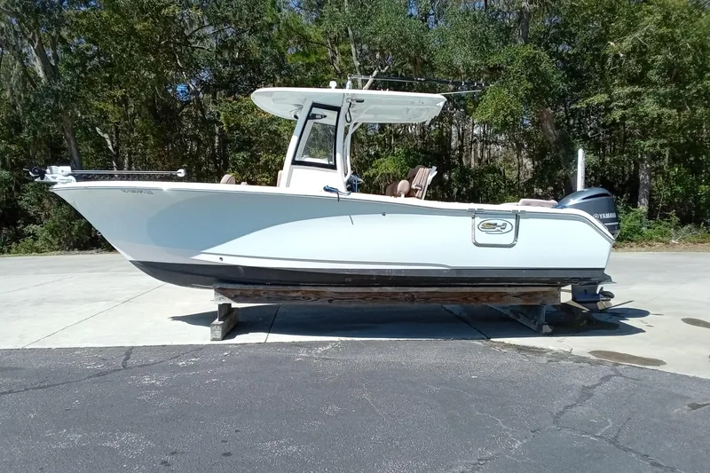 Slide: The Image of 2019 Sea Hunt Ultra 255 SE boat on display outdoors. - 3
