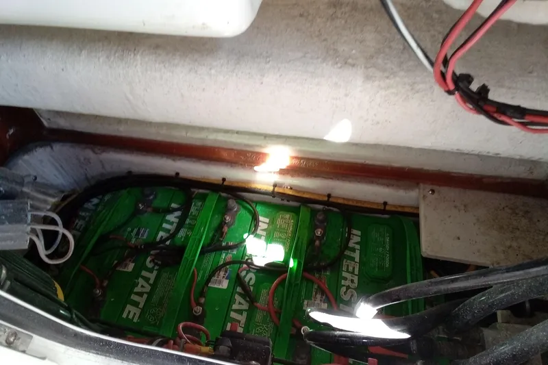 Slide: The Image of Battery compartment of 2019 Sea Hunt Ultra 255 SE boat with wiring. - 32