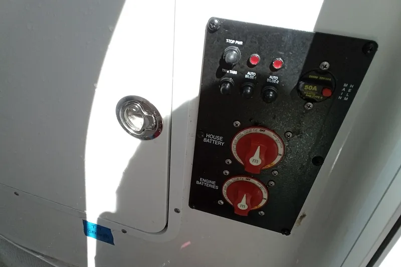Slide: The Image of Control panel of a 2019 Sea Hunt Ultra 255 SE boat, featuring battery switches. - 33
