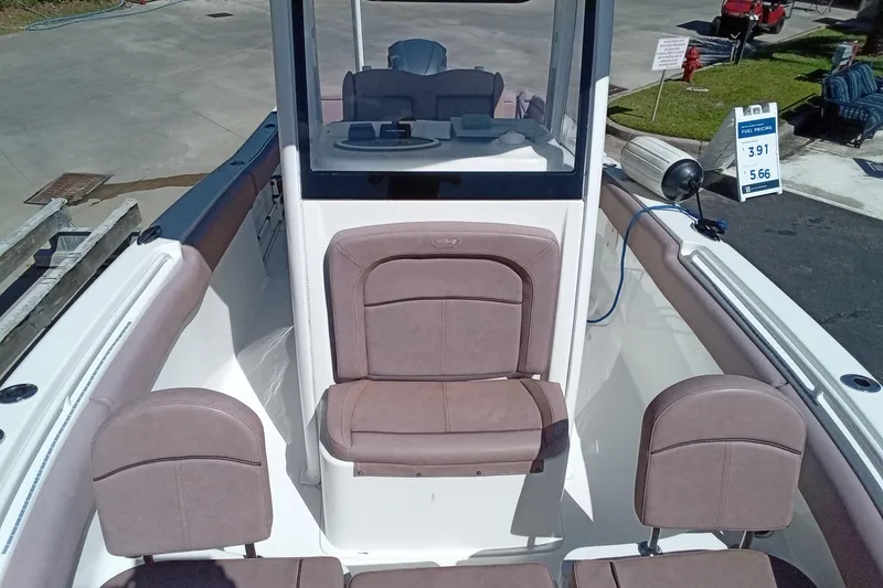 Slide: The Image of 2019 Sea Hunt Ultra 255 SE boat interior with cushioned seating and console view. - 39
