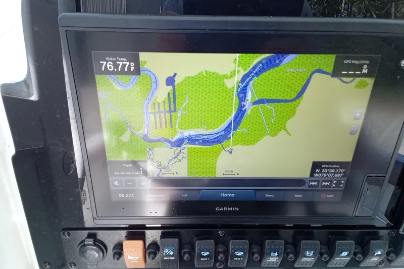 Slide: The Image of Garmin navigation display on 2019 Sea Hunt Ultra 255 SE, showing water temperature and GPS coordinates. - 45