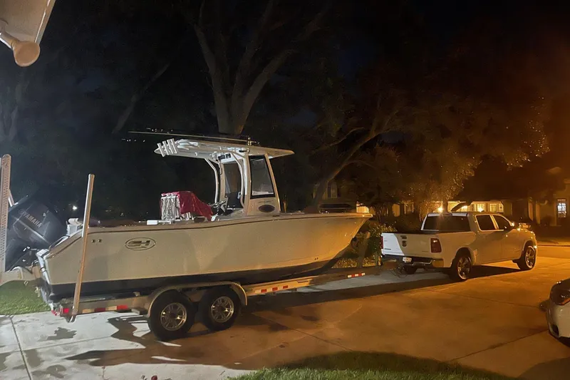 Slide: The Image of 2019 Sea Hunt Ultra 255 SE boat on trailer, parked at night in residential area. - 51