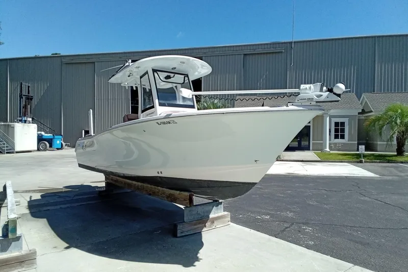Slide: The Image of 2019 Sea Hunt Ultra 255 SE boat on display outside a warehouse. - 6