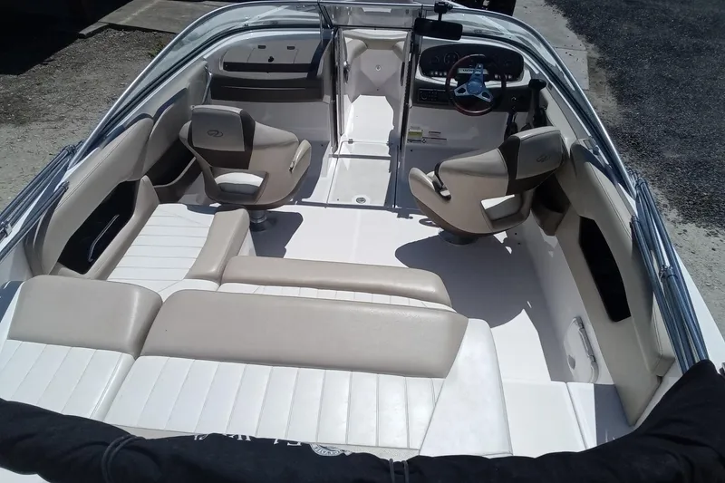 Slide: The Image of 2014 Regal 2000 Bowrider interior with beige seating and steering console. - 10