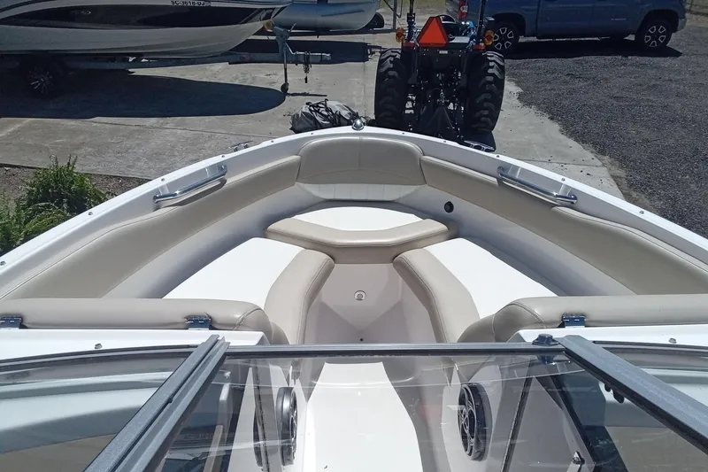 Slide: The Image of 2014 Regal 2000 Bowrider boat interior with beige seating and open bow design. - 14