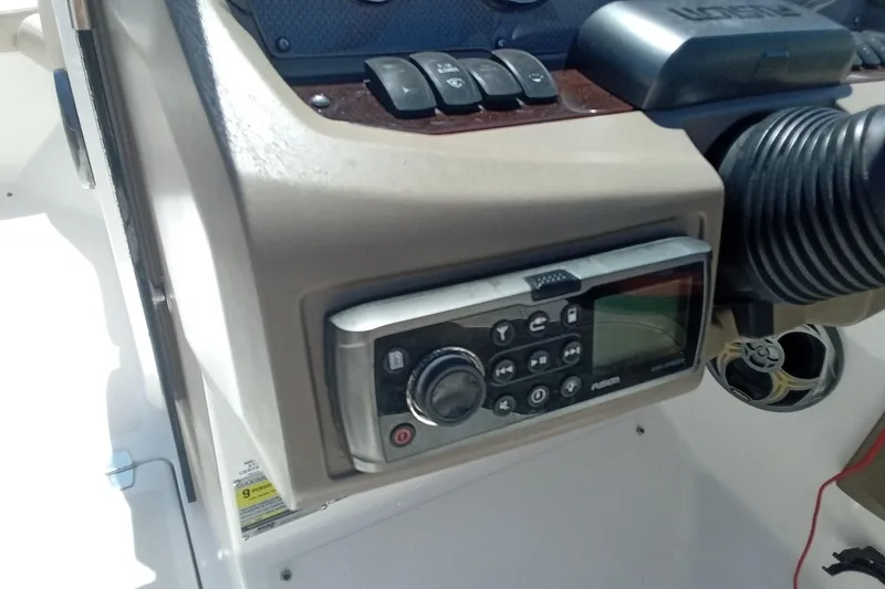 Slide: The Image of Control panel of a 2014 Regal 2000 Bowrider boat with audio system and switches. - 17