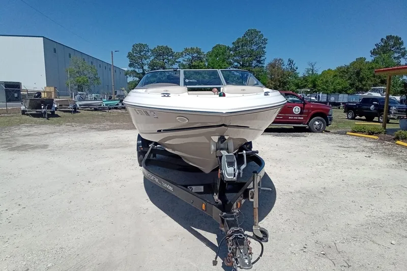 Slide: The Image of 2014 Regal 2000 Bowrider boat on trailer in outdoor setting. - 4