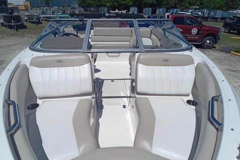 Slide: The Image of 2014 Regal 2000 Bowrider boat interior with beige and white seating. - 6