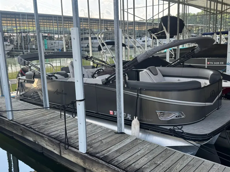 The Image of 2021 Avalon LSZ 2485 Ent pontoon boat docked in a marina. - 0
