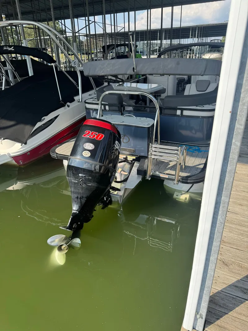 Slide: The Image of 2021 Avalon LSZ 2485 Ent pontoon boat with Suzuki 250 outboard motor docked in marina. - 10