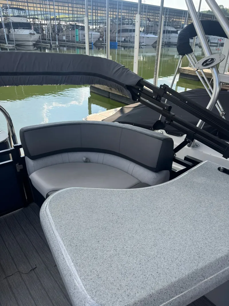 Slide: The Image of 2021 Avalon LSZ 2485 Ent boat interior with seating and table, docked at marina. - 3