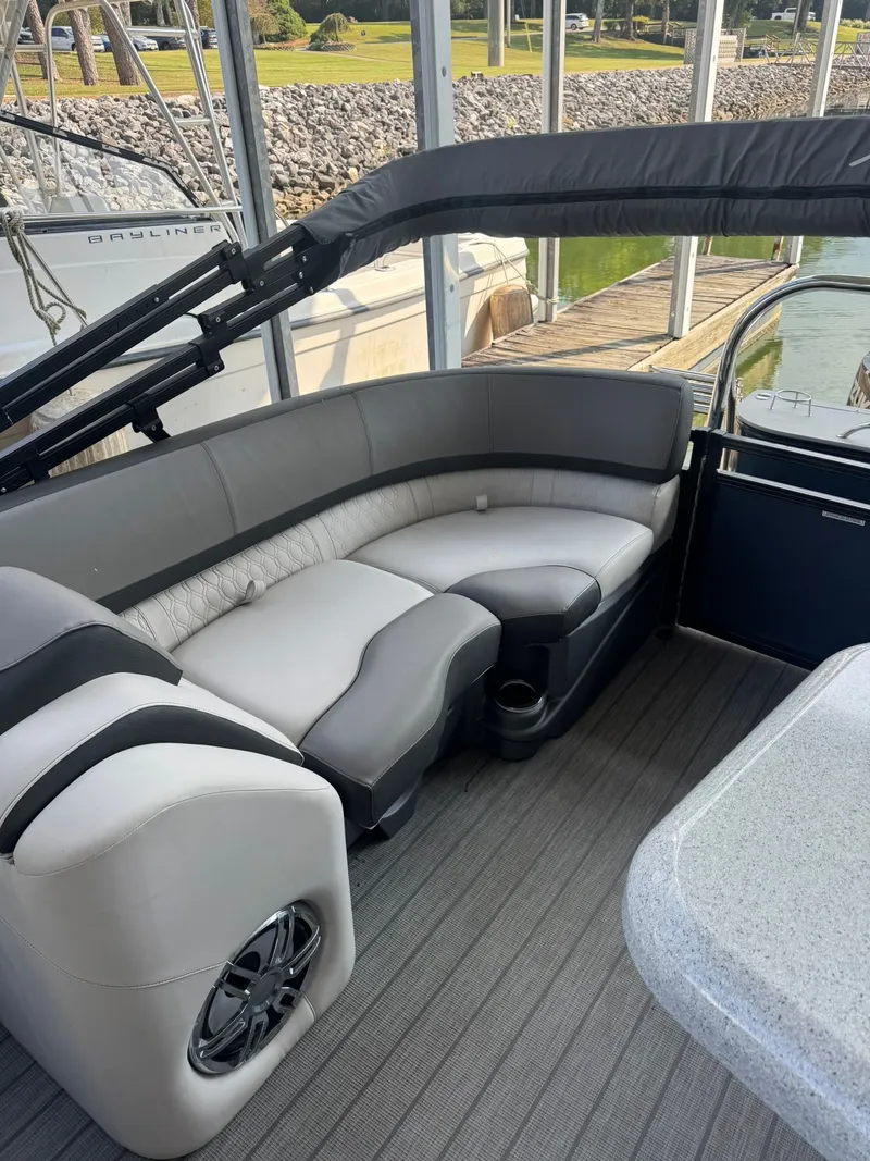 Slide: The Image of 2021 Avalon LSZ 2485 Ent pontoon boat interior with plush seating and modern design. - 4
