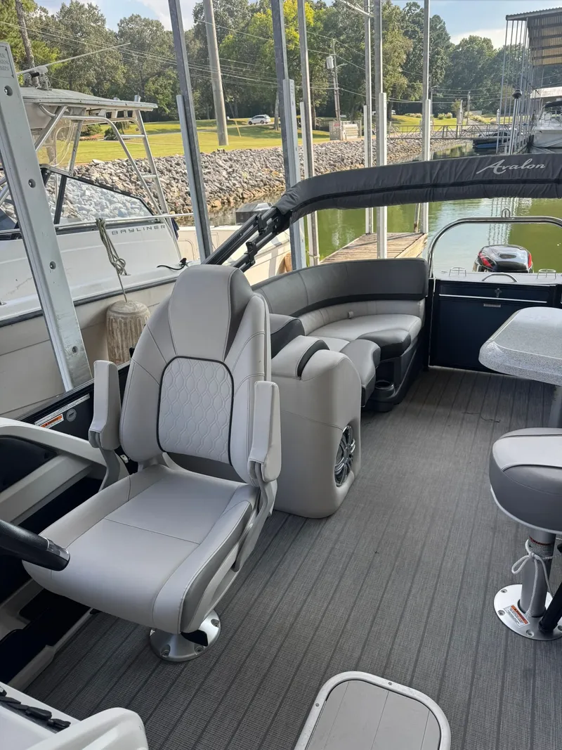 Slide: The Image of 2021 Avalon LSZ 2485 Ent pontoon boat interior with plush seating and modern design. - 6
