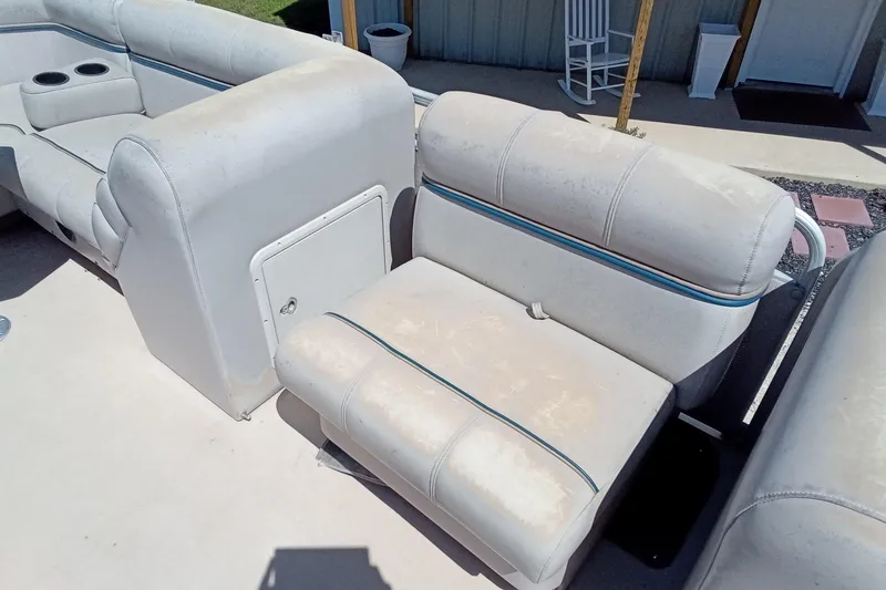 Slide: The Image of 2003 Godfrey SANPAN 2500 boat seating with storage compartment, light wear visible. - 14