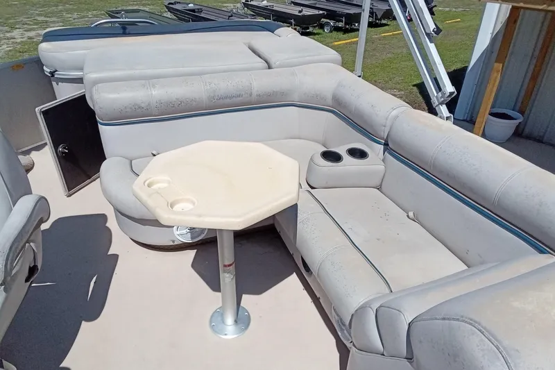 Slide: The Image of 2003 Godfrey SANPAN 2500 pontoon boat interior with seating and table. - 15
