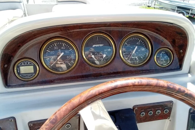 Slide: The Image of Dashboard of a 2003 Godfrey SANPAN 2500 boat with wooden steering wheel and gauges. - 19