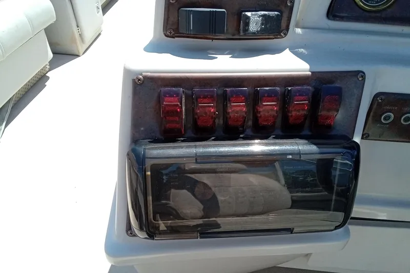 Slide: The Image of Control panel of a 2003 Godfrey SANPAN 2500 boat with switches and buttons. - 20