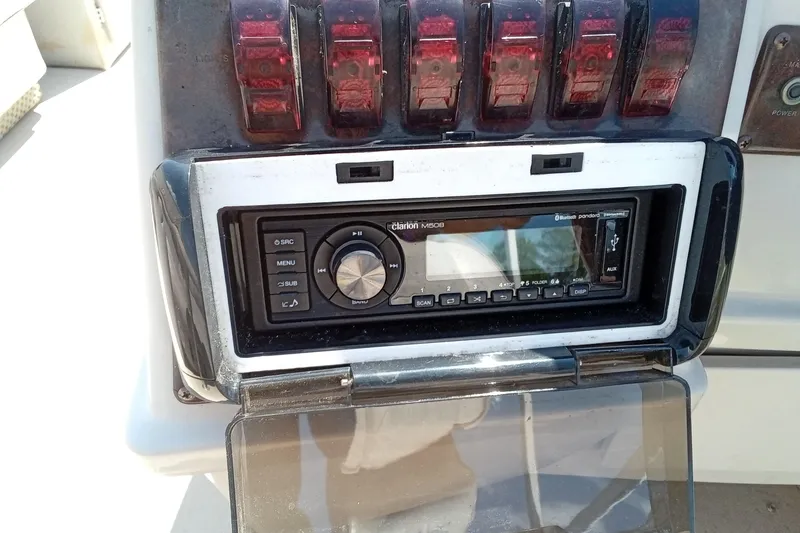 Slide: The Image of Boat dashboard with Clarion stereo system on a 2003 Godfrey SANPAN 2500. - 21